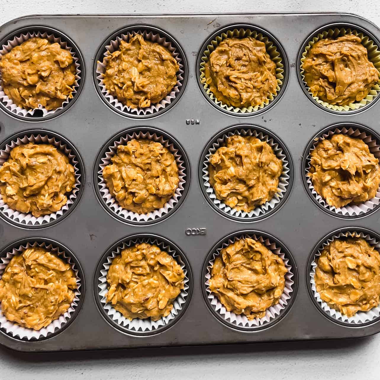 muffin pan filled with batter for Easy Vegan and Gluten-Free Pumpkin Oatmeal Muffins