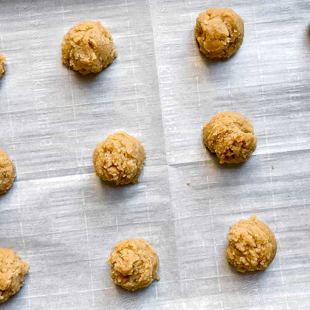 balls of cookie batter on baking sheet for Easy Vegan and Gluten-Free Thumbprint Cookies Filled with Apple Butter