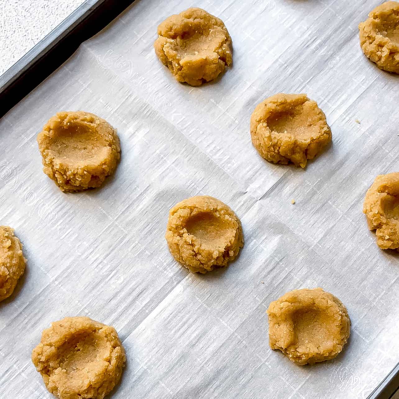 thumbprint in cookie dough batter for Easy Vegan and Gluten-Free Thumbprint Cookies Filled with Apple Butter