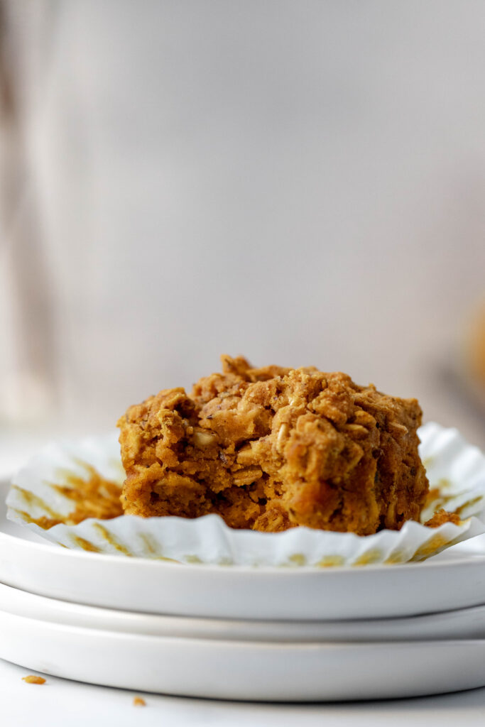 Easy Vegan and Gluten-Free Pumpkin Oatmeal Muffin on plate with bite taken out of it