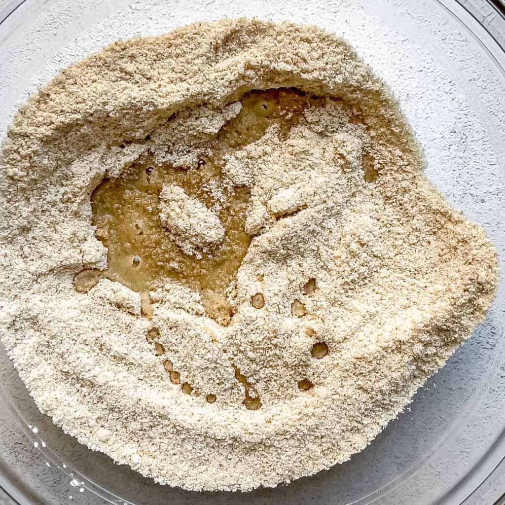bowl of flour mixture with wet ingredients for Easy Vegan and Gluten-Free Thumbprint Cookies Filled with Apple Butter